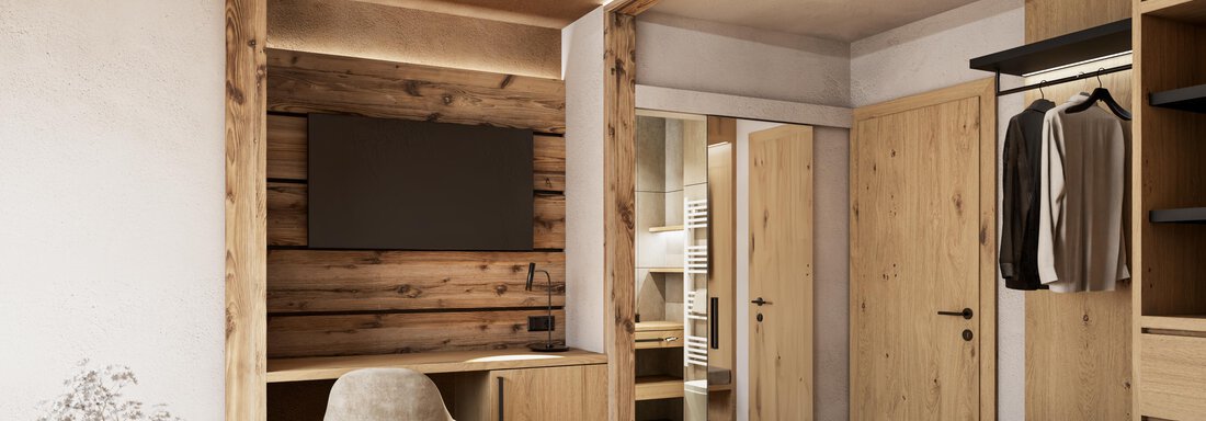 Ein modernes Schlafzimmer mit Holzdetails und einem großen Bett. Es gibt einen Fernseher und einen Kleiderschrank sowie eine entspannte Atmosphäre. - Hotel Tauferberg - Niederthai