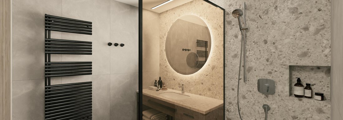 A modern bathroom with a shower and a round mirror. On the wall, there is a towel holder and a wooden washbasin. - Ferienwohnung de Luxe Alpenresidenz am Mühlbach - Obergurgl 