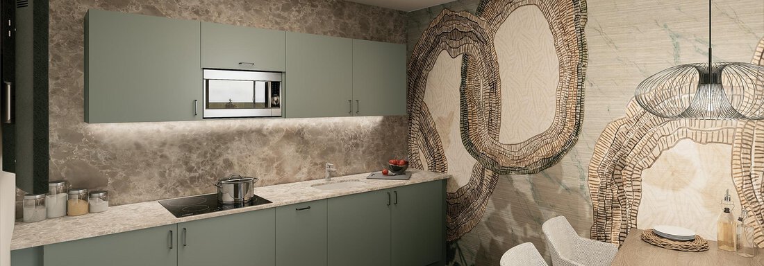Wohnen A modern kitchen with green cabinets and a stylish stone wall. A dining table with white chairs is visible in the background. - Ferienwohnung de Luxe Alpenresidenz am Mühlbach - Obergurgl